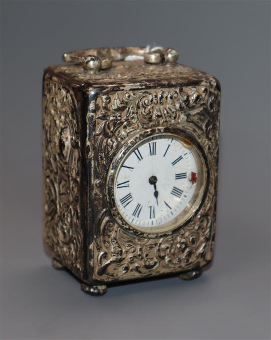 A late Victorian repousse silver cased miniature carriage timepiece by William Comyns, London, 1898, retailed by Asprey,